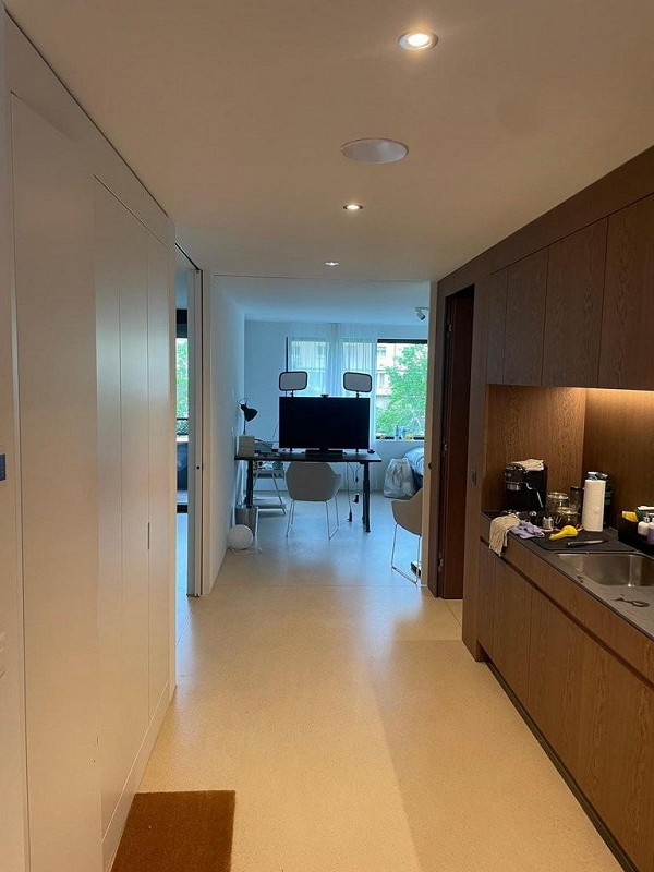 Hallway leading to an open kitchen, dining and living area with a view