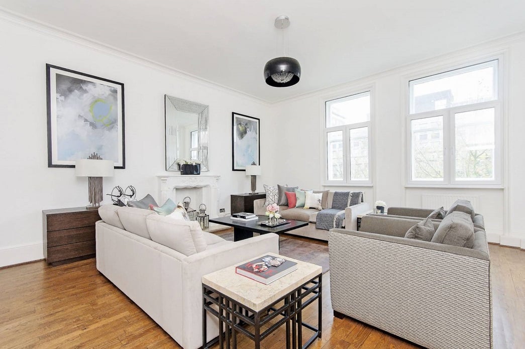 spacious living room with a fireplace, modern wooden furniture, and a warm color palette
