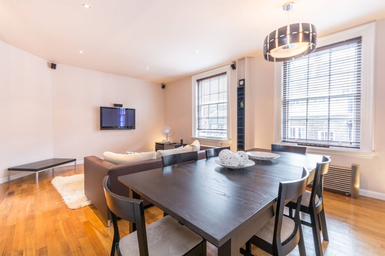 Dining table, chairs, sofa, carpet, coffee table, television