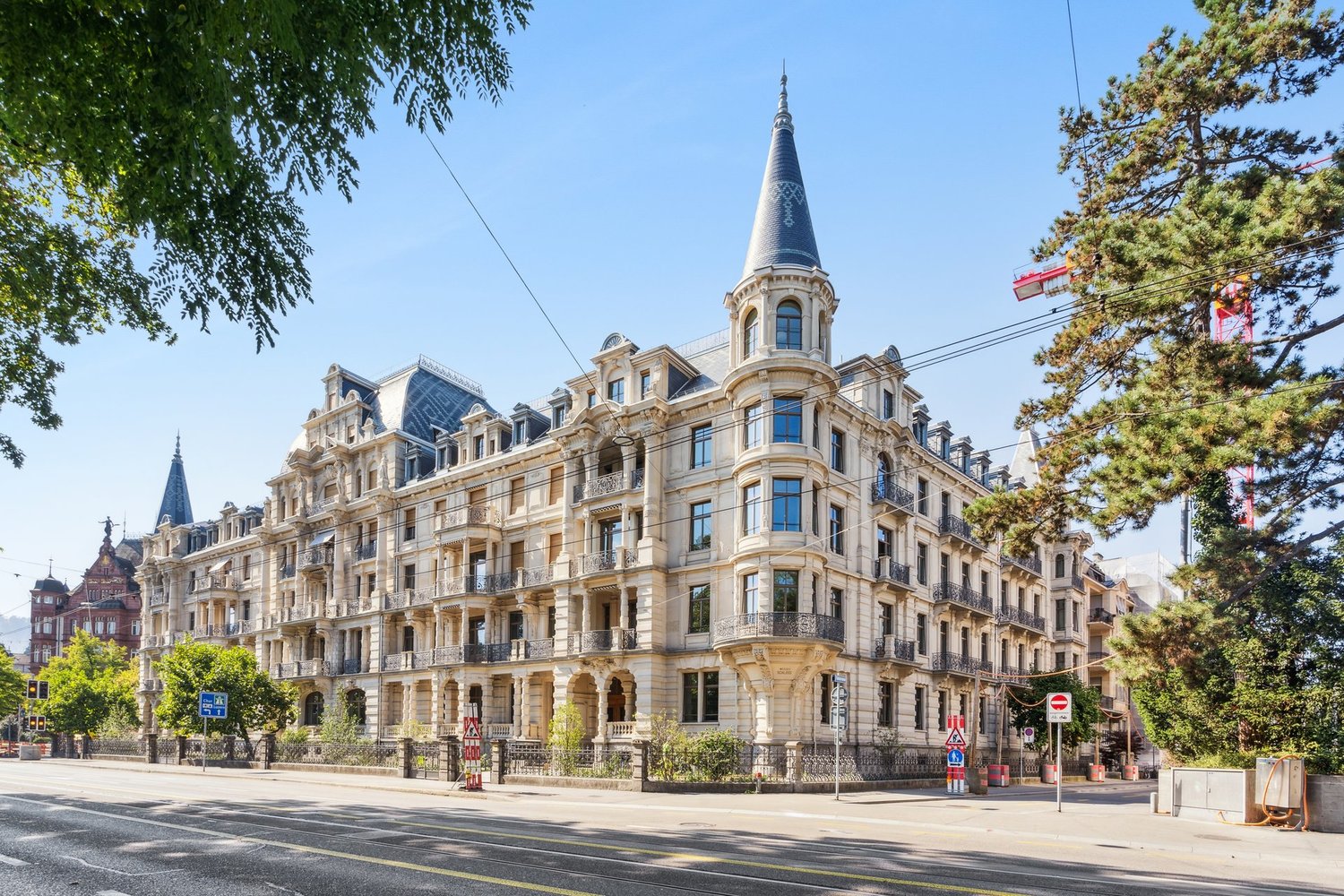 Ornate classical building, several floors, balcony on second floor, turrets