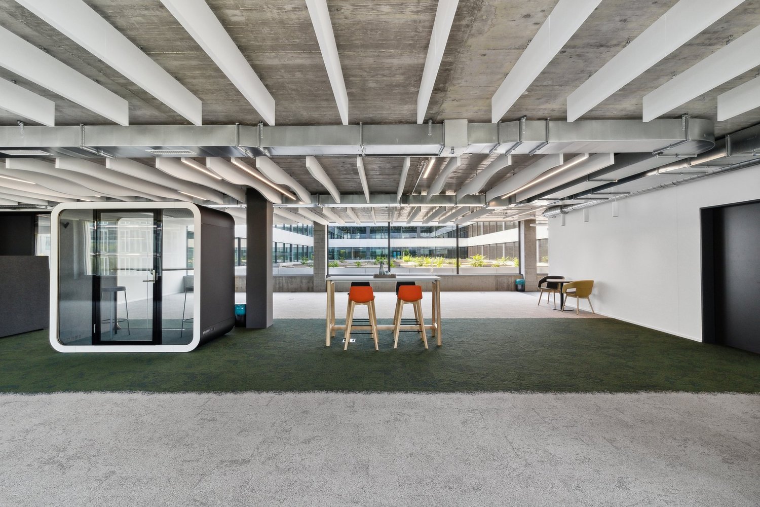 Large room with open office layout, modern furniture, and wide floor area