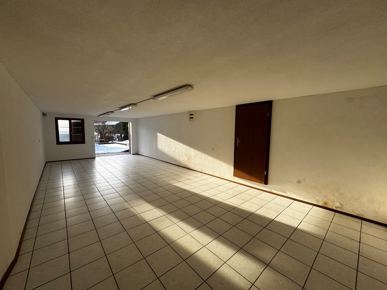 empty room, white tiles, fluorescent lighting, doorway