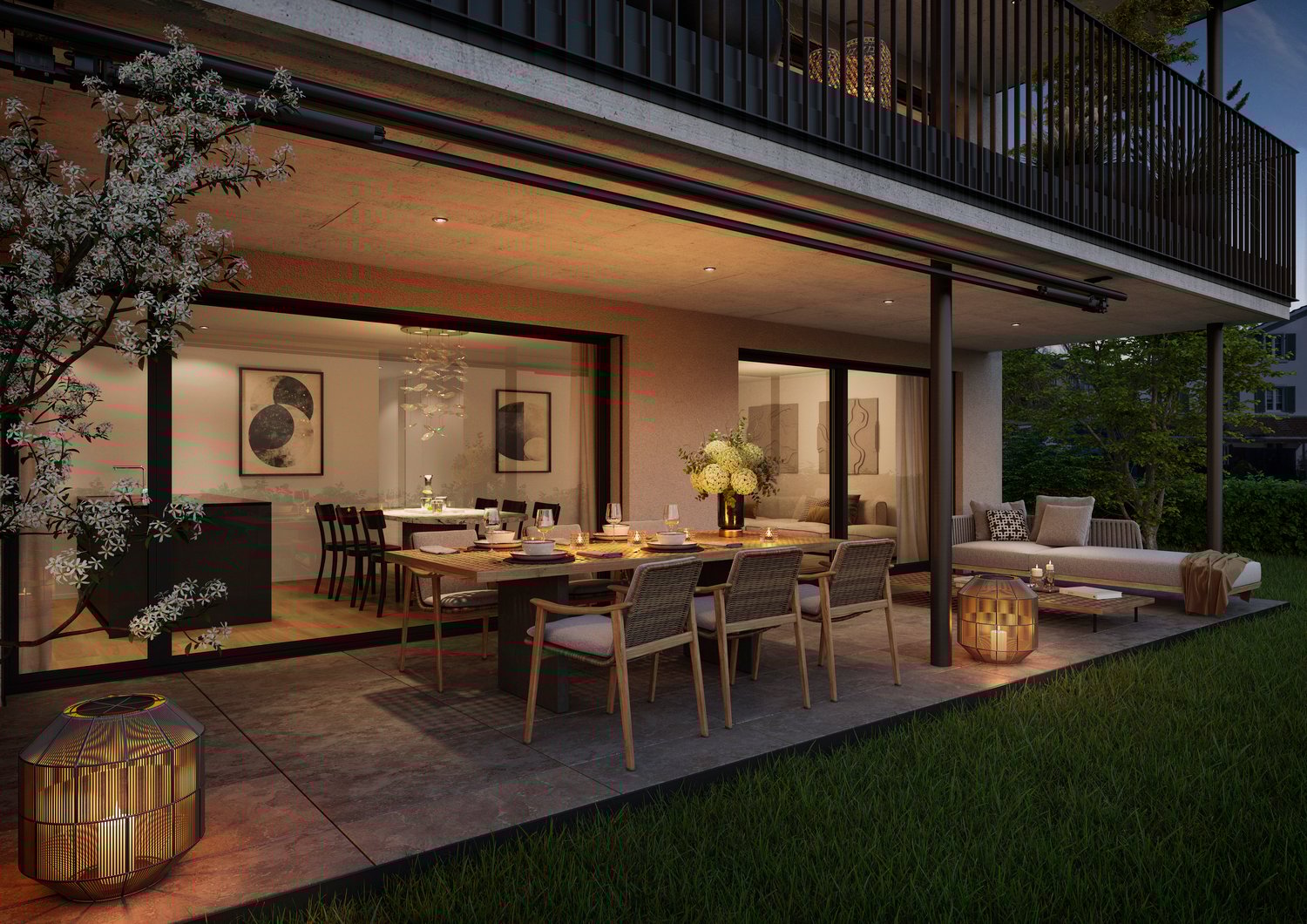 Spacious outdoor dining and living area with a large wooden table, wicker chairs, and a cozy seating area. The space is surrounded by a balcony with a wooden railing and features decorative lighting fixtures. The area is well-lit and has a warm, inviting