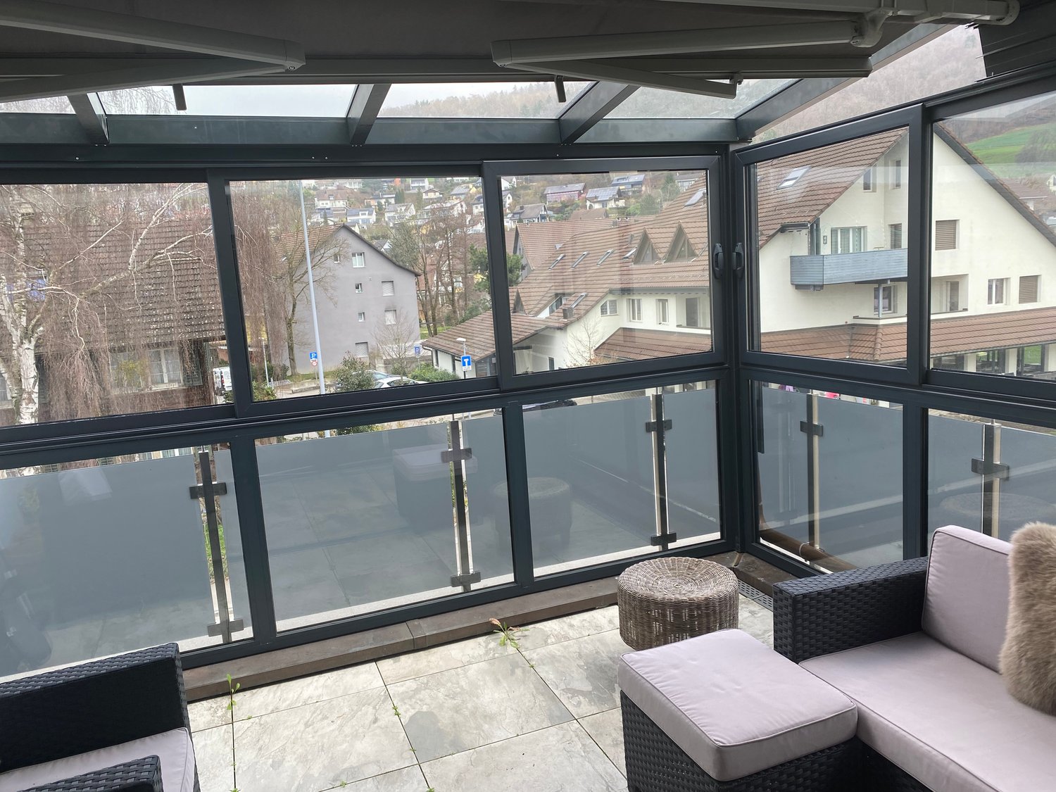 Balcony, large windows, tiled floor, modern furniture