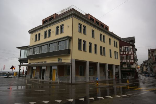 Commercial building, multiple windows, modern architecture, located on a street corner.
