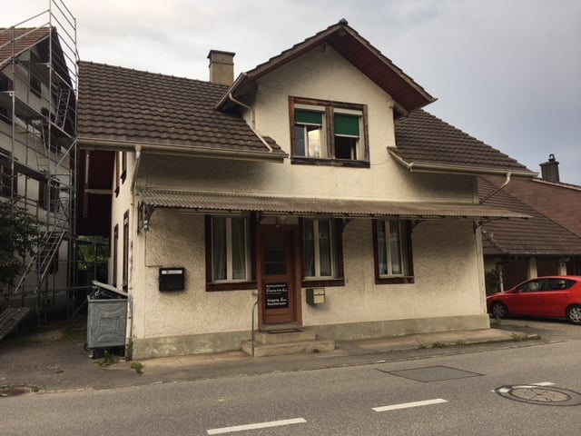 single-family house, beige walls, brown roof, awning, glass windows, door