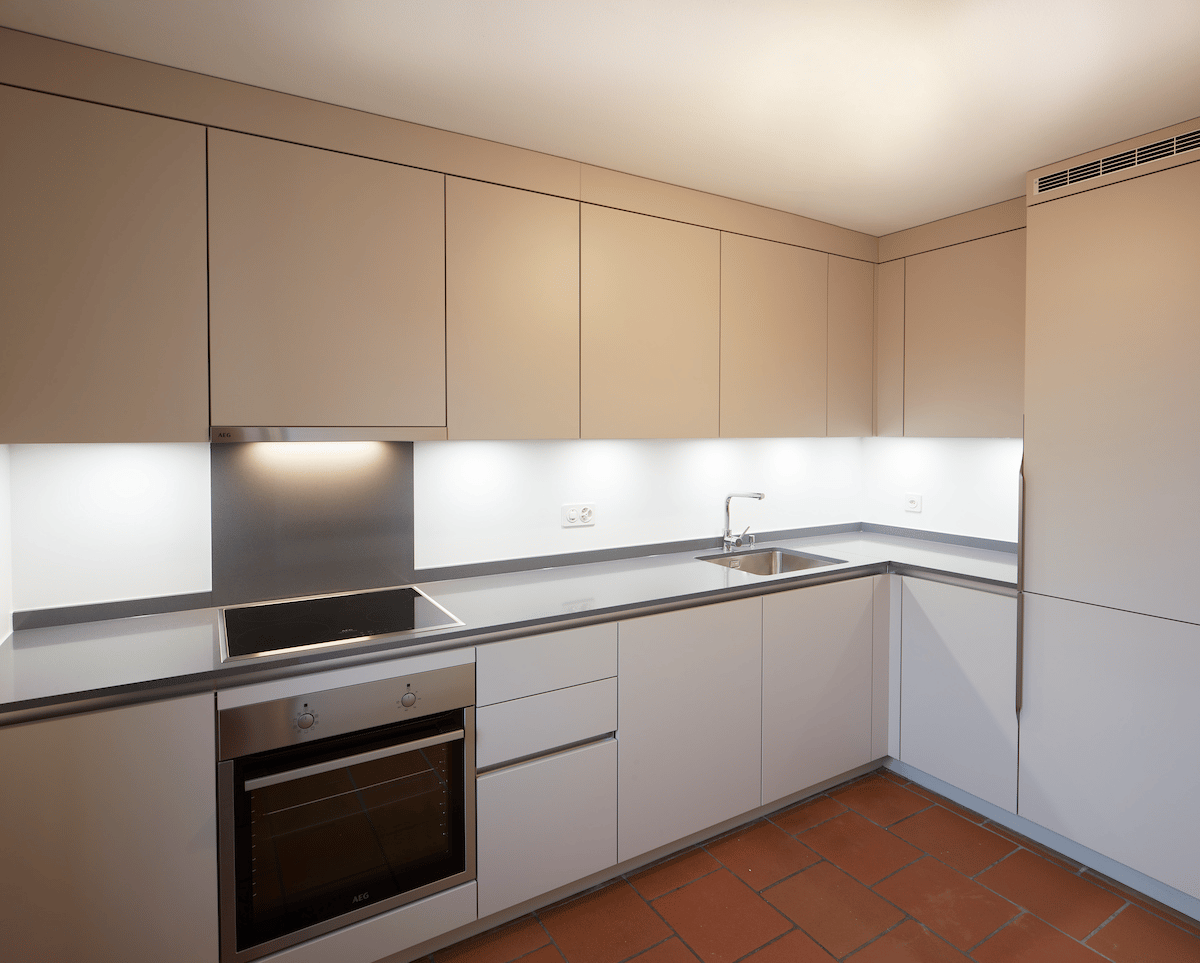 modern kitchen, silver AEG appliances, stainless steel sink, ceramic tiles, tiled backsplash