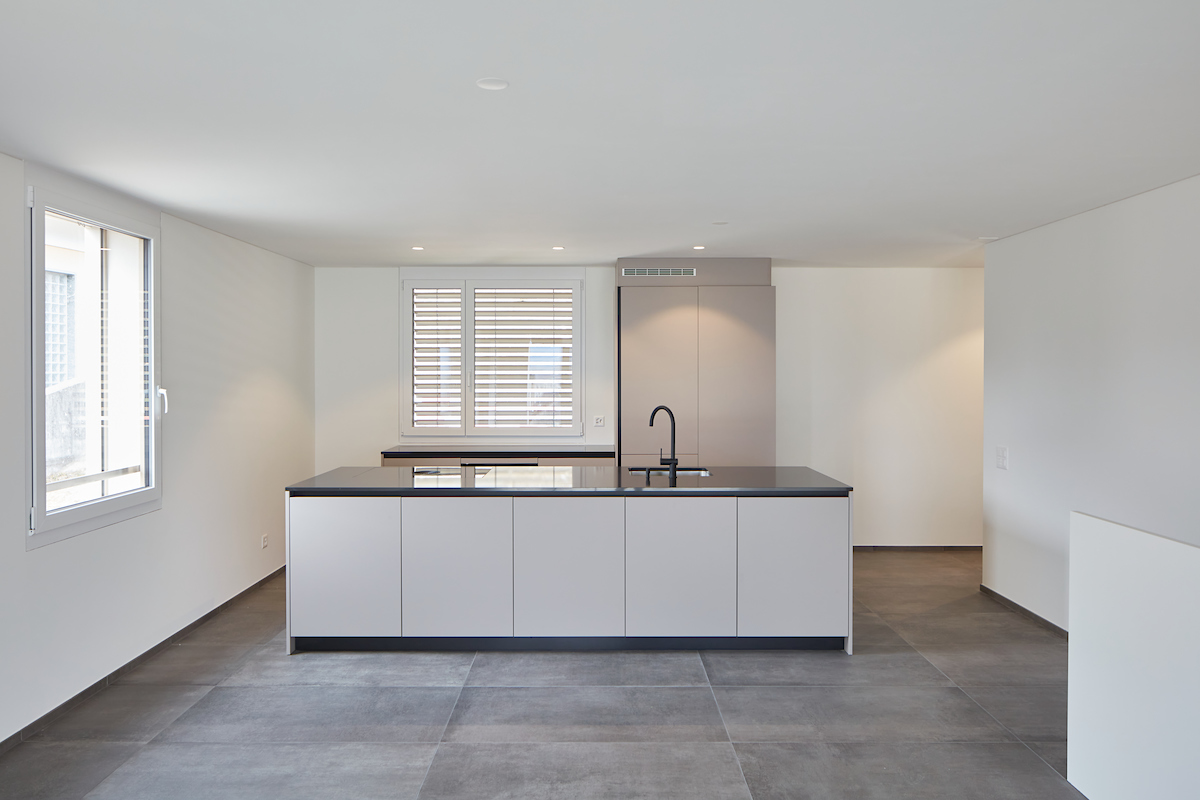 open kitchen, white cabinets, countertop, sink, window with shutter