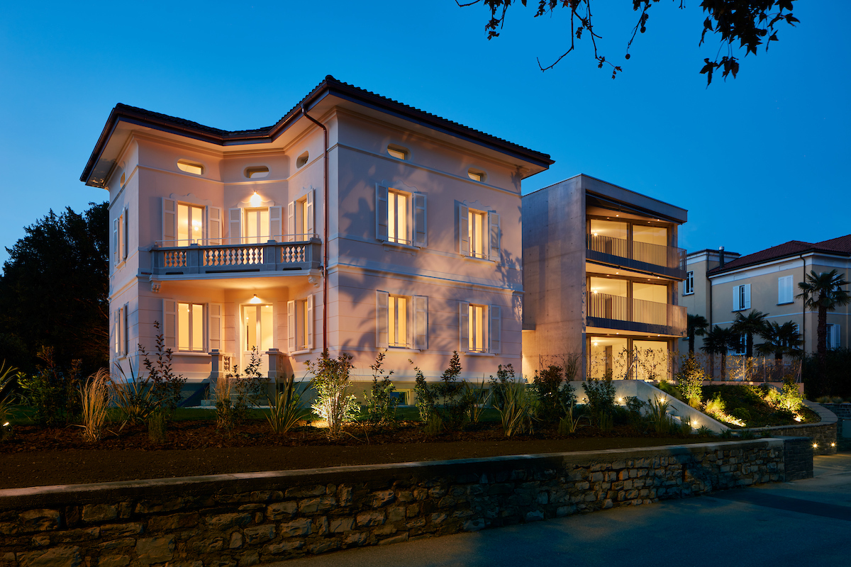 2 story villa, lit up, balcony, large windows, white exterior