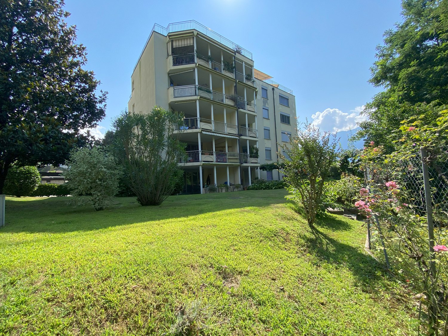 multistory building, balconies, garden, trees, grass, blue sky