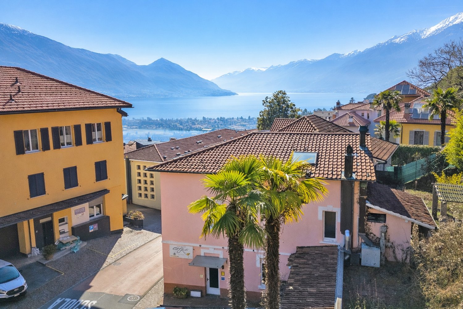 Aerial view of buildings with mountains and lake in the background
