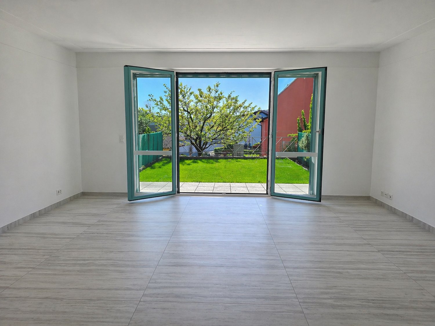 empty room, large glass doors, wooden floor, white walls, garden view