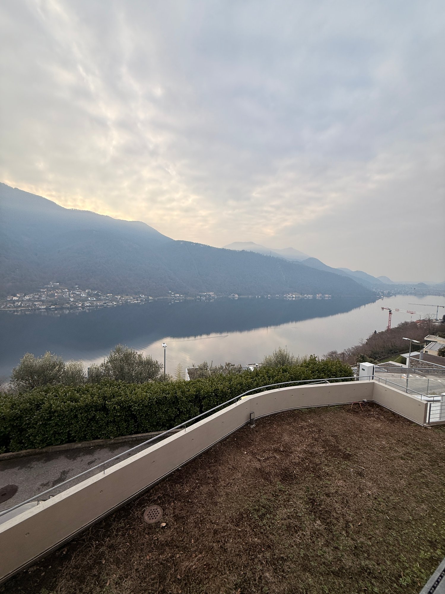 roof terrace with a lake view, mountains in the background, fenced