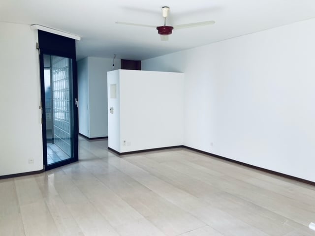 empty room, white walls, hardwood floor, ceiling fan, open sliding glass door