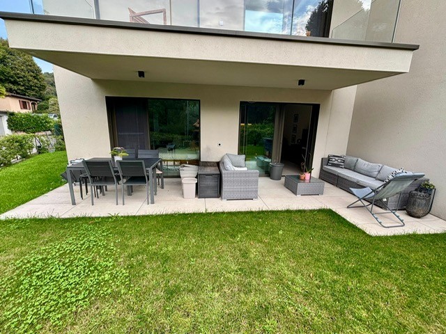 modern building with a patio that includes a dining set and a lounge set