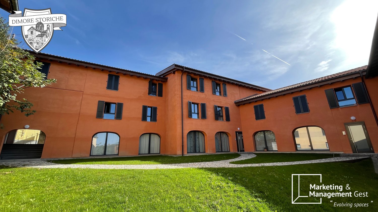 modern building with several windows, grass garden in front