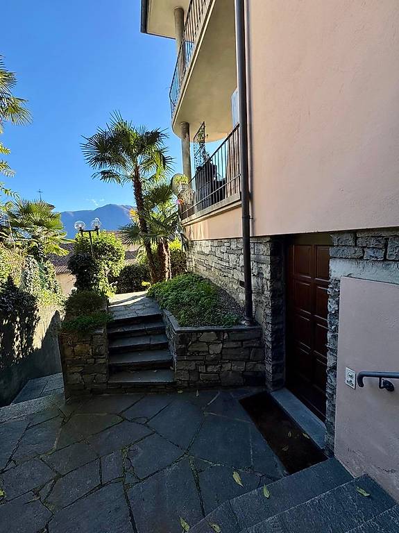 Stone wall, stone steps, balcony, palm trees, mountain view