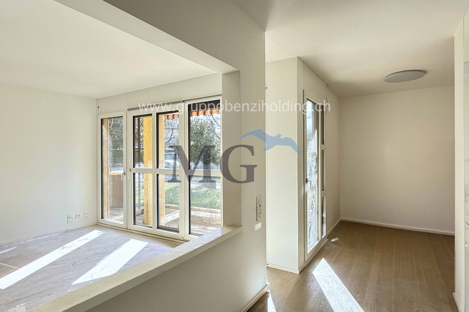 large glass doors, wooden floor, white walls, balcony, window