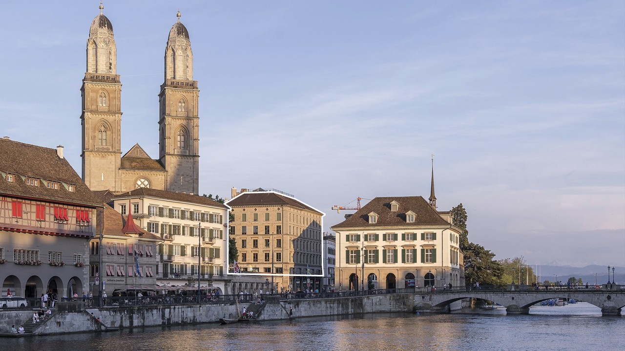 Modern building with medieval church in the background and a river in the foreground