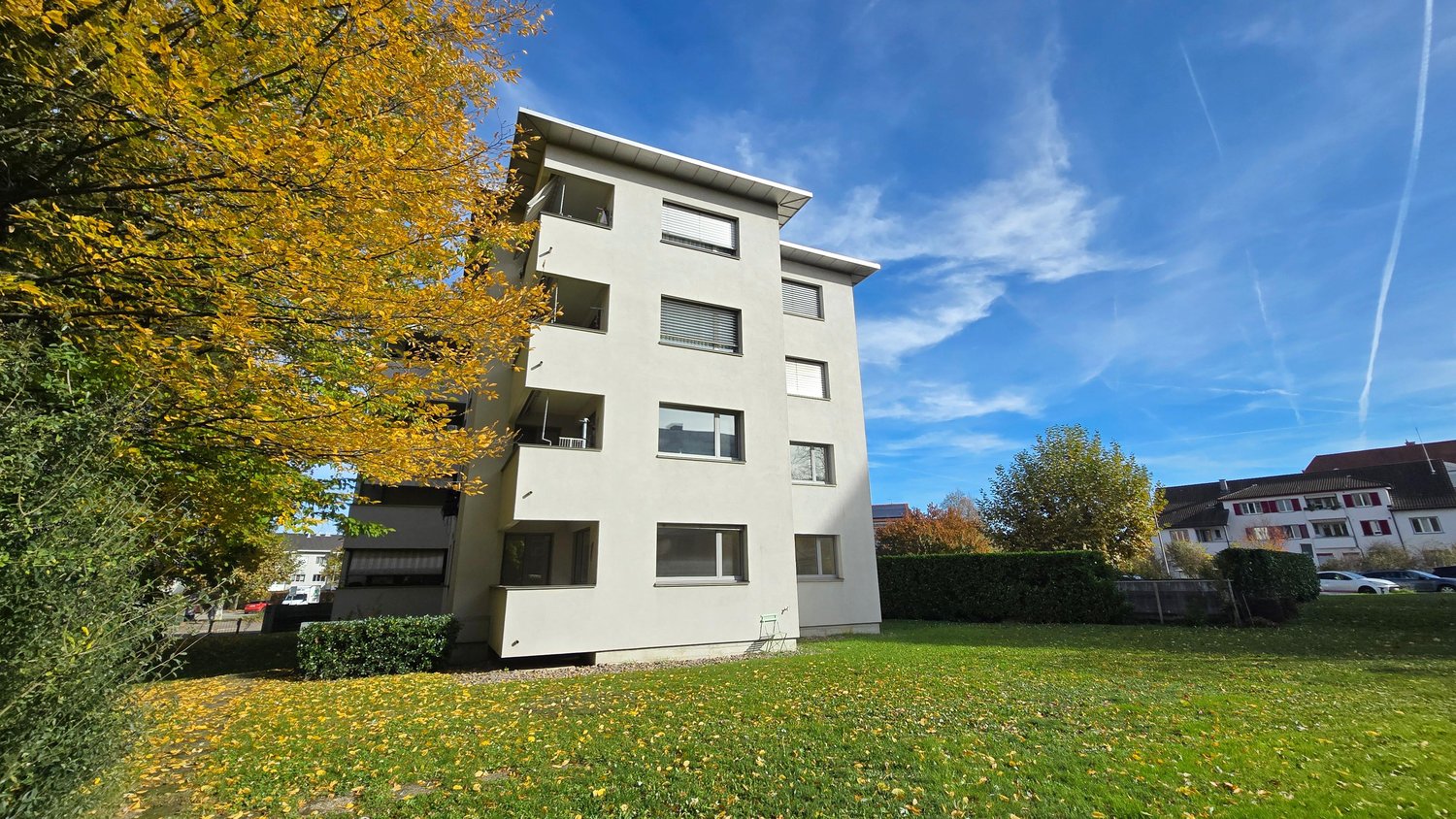 4 story house, concrete construction, windows, balcony, trees, grass