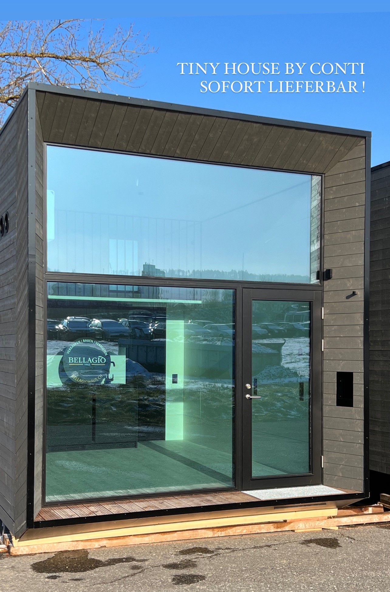 tiny house, glass windows, double doors, wooden siding, carport visible