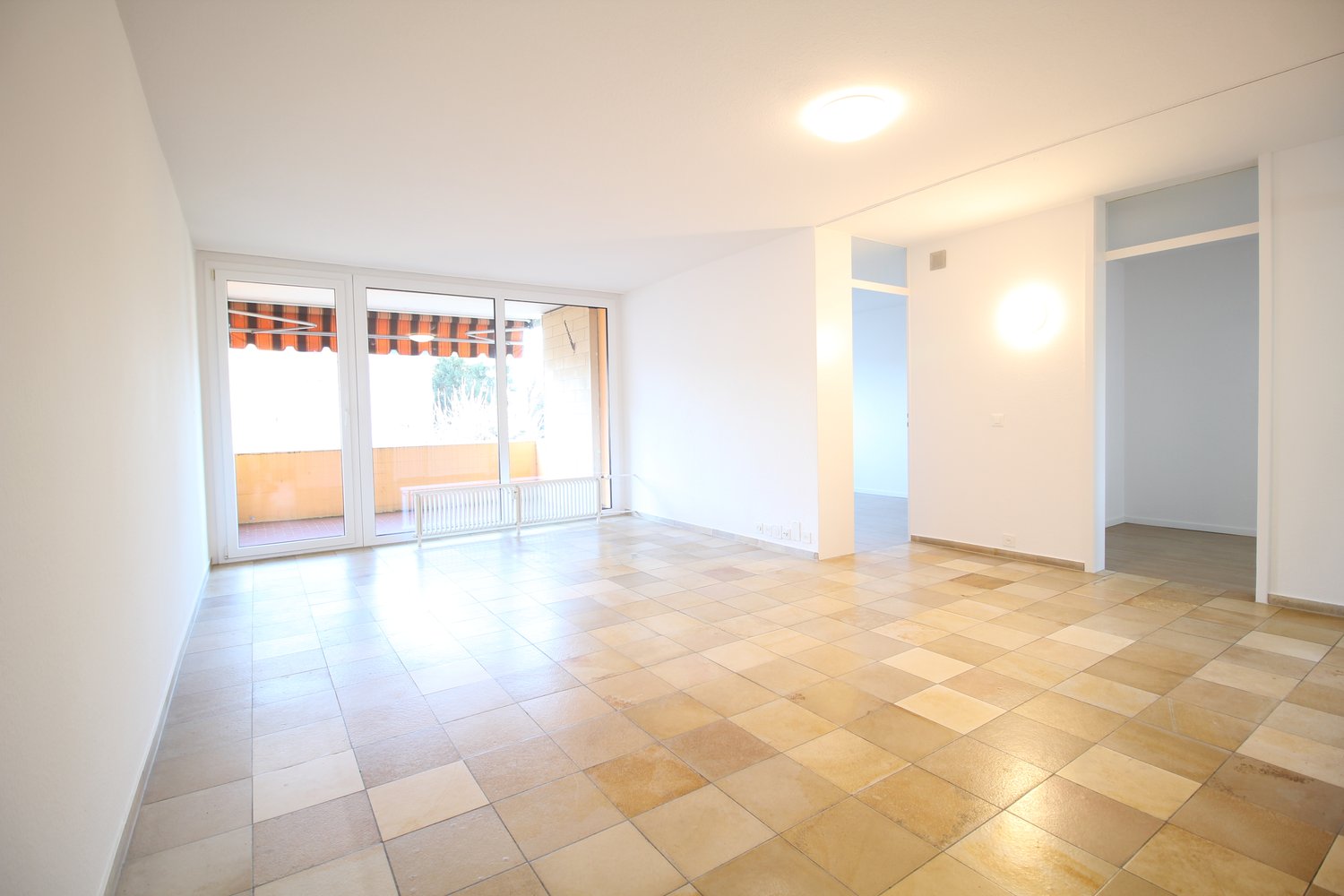 tiled floor, large windows leading to balcony, open layout