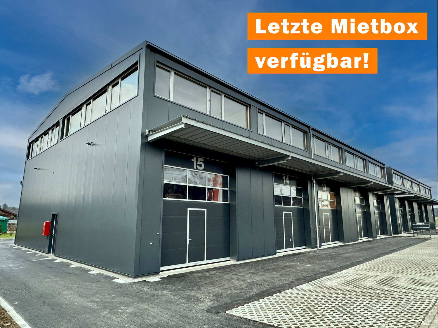 warehouse style building, multiple doors and windows, garage entrance
