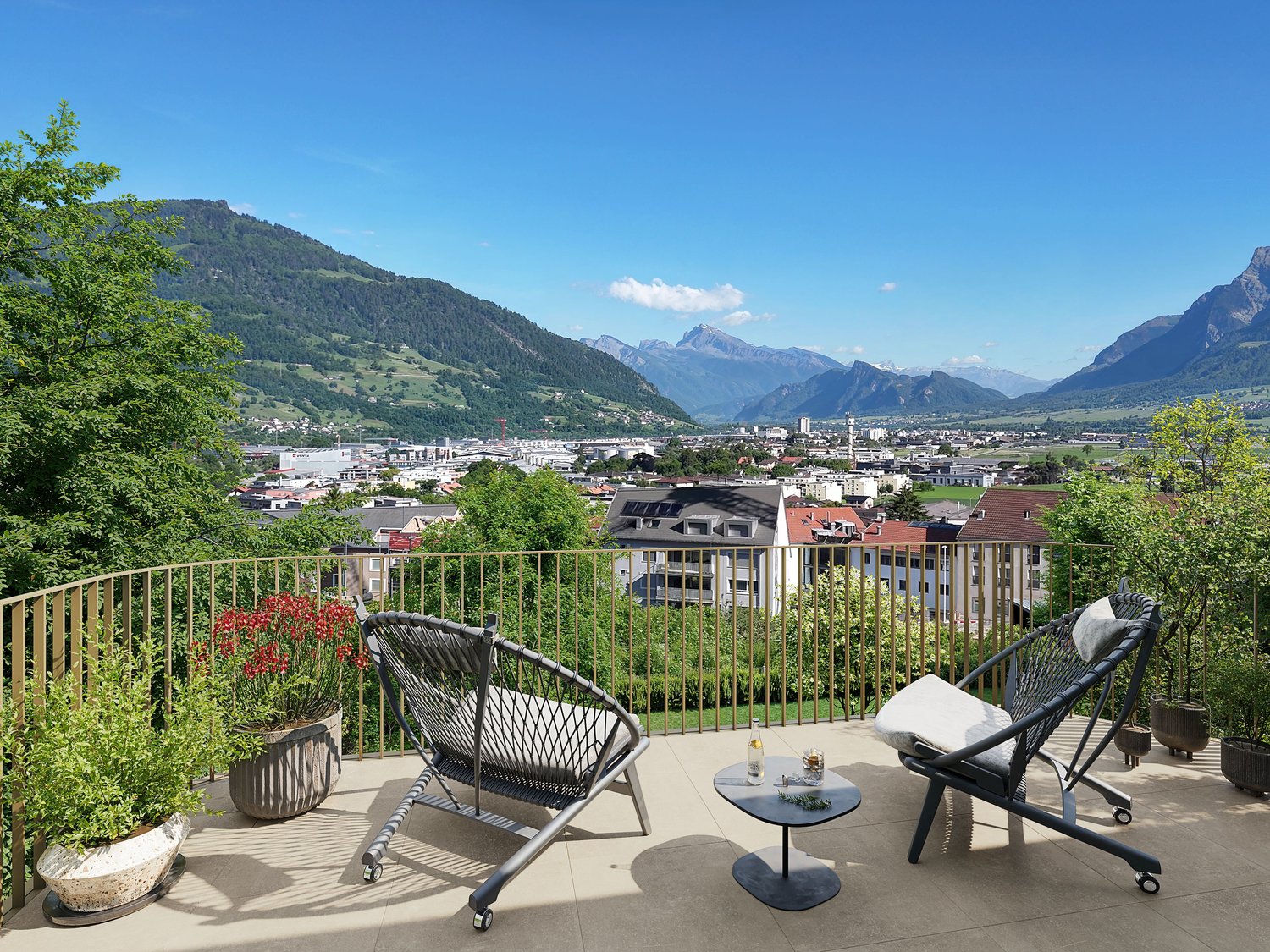 balcony with 2 chairs, a table with plants, a railing and a beautiful mountain view