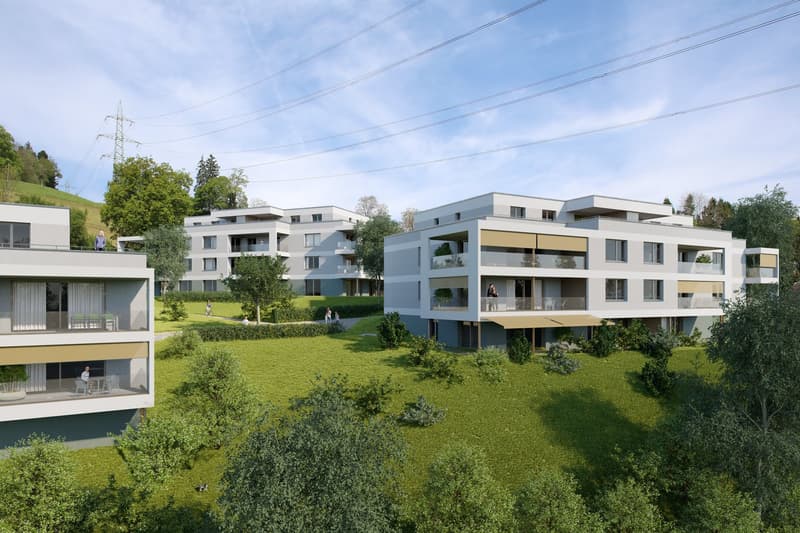 Three apartment buildings, three-story, balconies, surrounded by green lawn and trees.