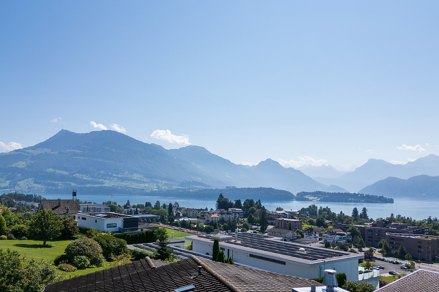aerial view of mountains, lake, town, buildings and houses