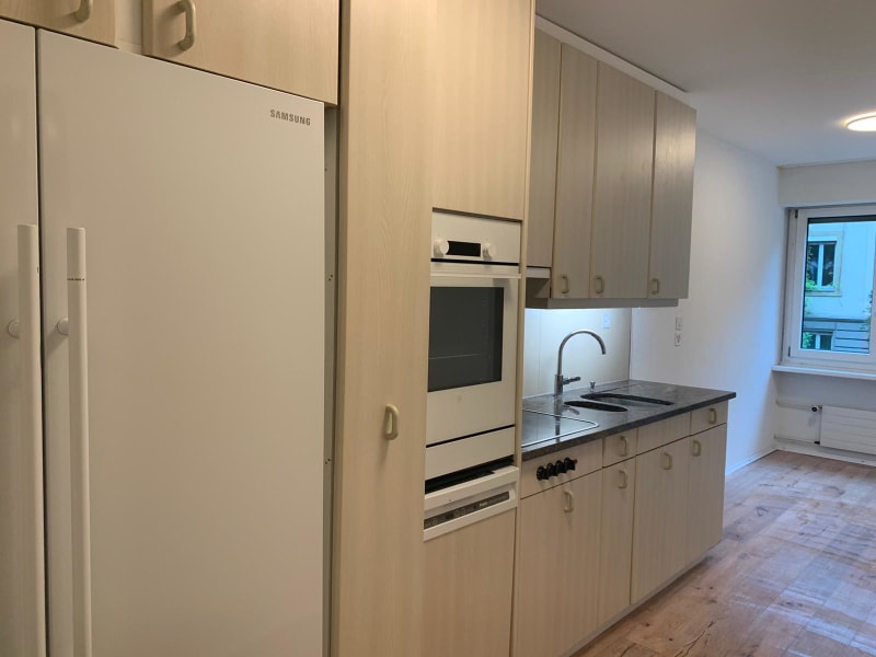 kitchen with wooden cabinets, granite countertop, sink, oven, dishwasher, fridge
