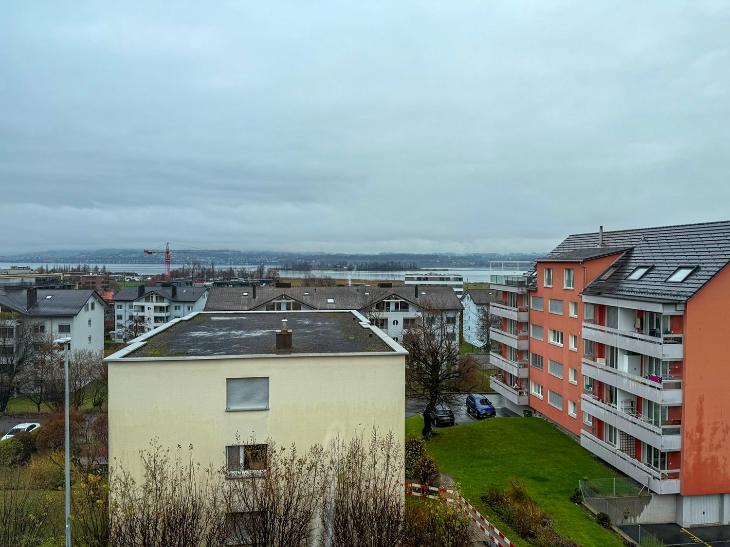 Aerial view of residential buildings with waterfront in the distance