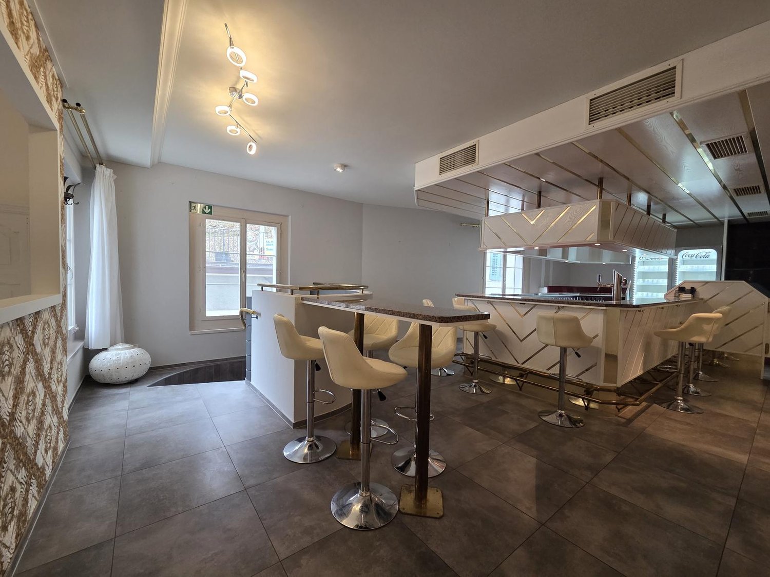 modern bar counter, white leather chairs, tiled floor, white walls, modern lighting