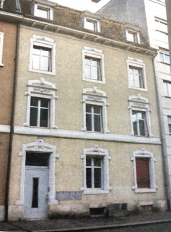 3 story house, beige walls, white windows, white door, multiple windows