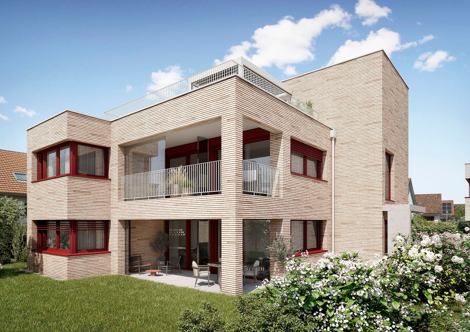 Two-story modern house with a wooden facade, large windows, and balconies. The house is surrounded by a well-maintained garden with flowering plants.