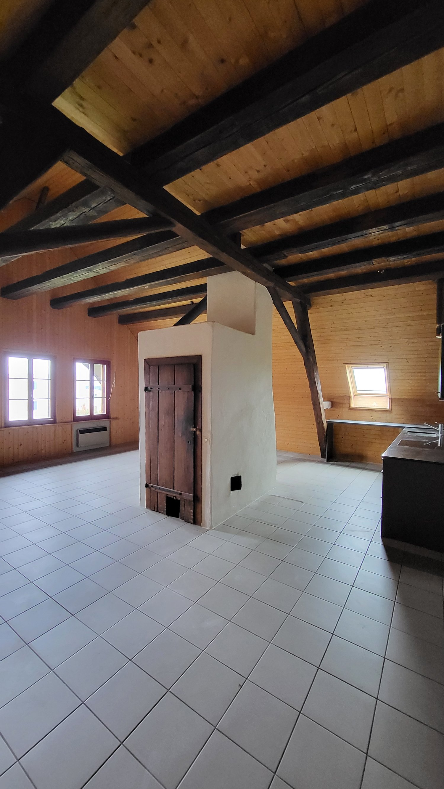 tiled floor, wood walls, fireplace, large windows