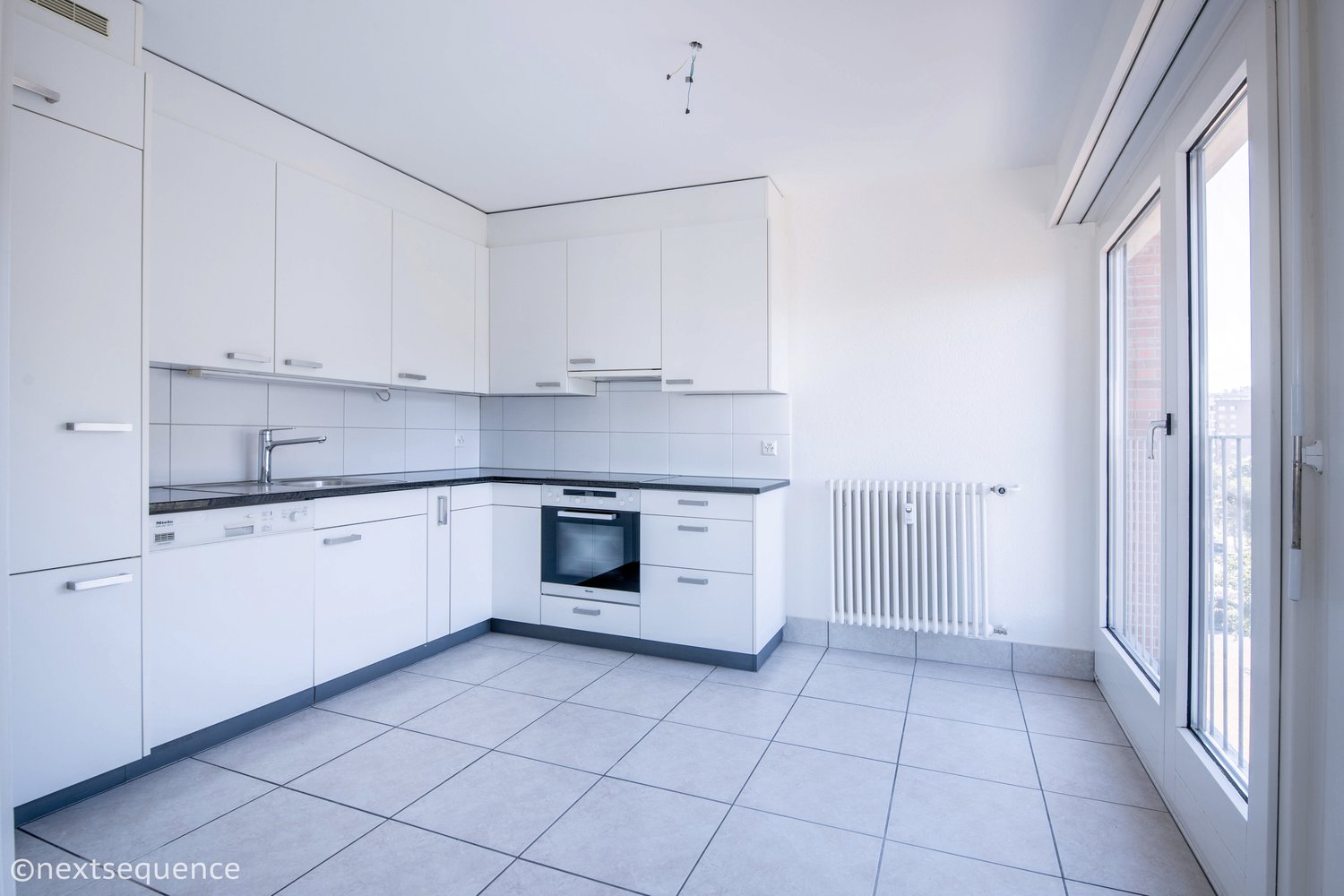 modern kitchen with white cabinets, tiled flooring, stainless steel appliances, gas stove, oven, dishwasher, sink, faucet, and a window leading to a balcony