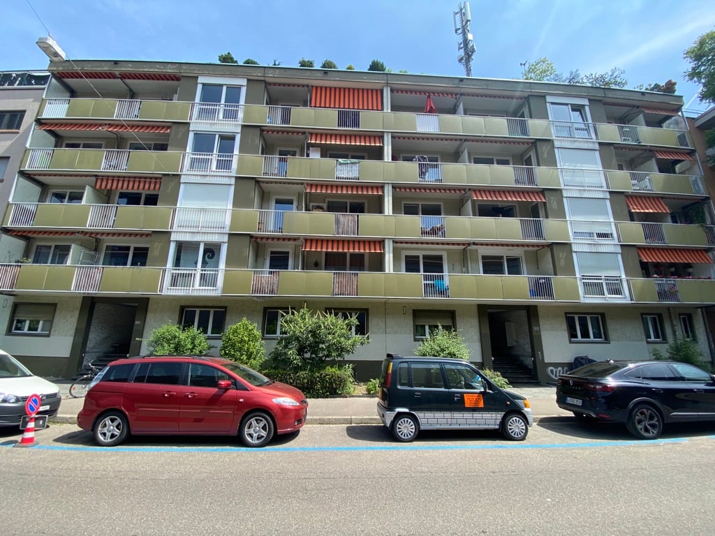 apartment building with balconies and several windows on each floor