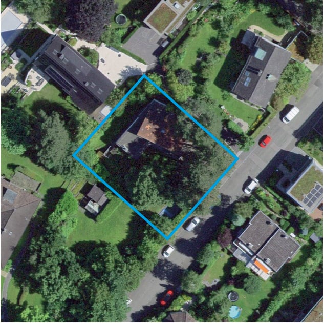 Aerial view of houses with garages, driveways, and car parked