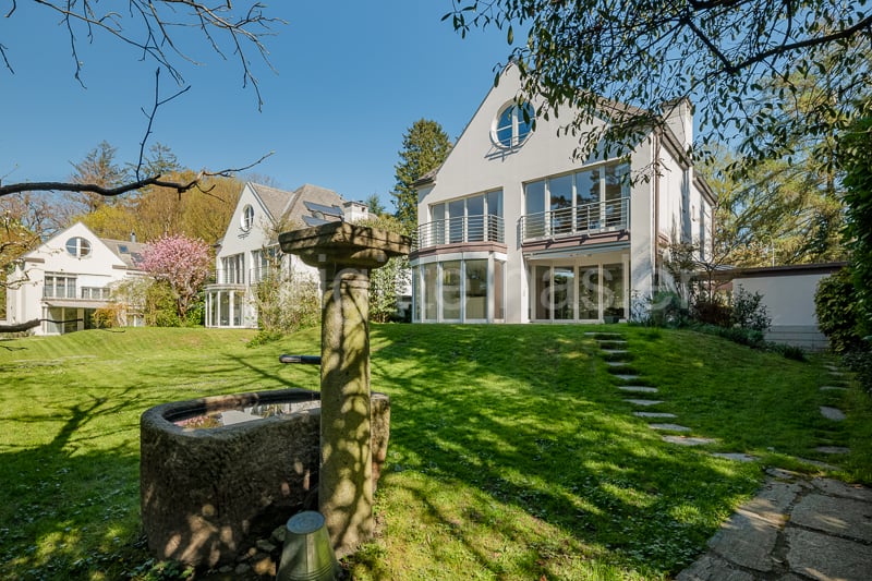 Modern house, white exterior, large windows, balcony, garden, fountain, lawn