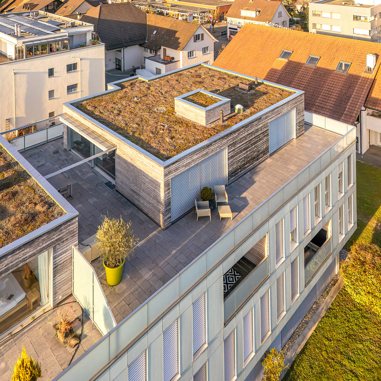top view, modern architecture, multiple floors, large windows, green rooftop