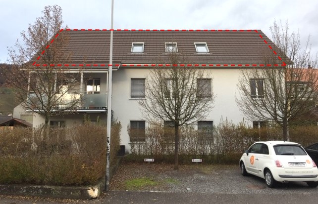 Three story house, white exterior, grey roof, balcony, large windows, red trim, hedges, parking area