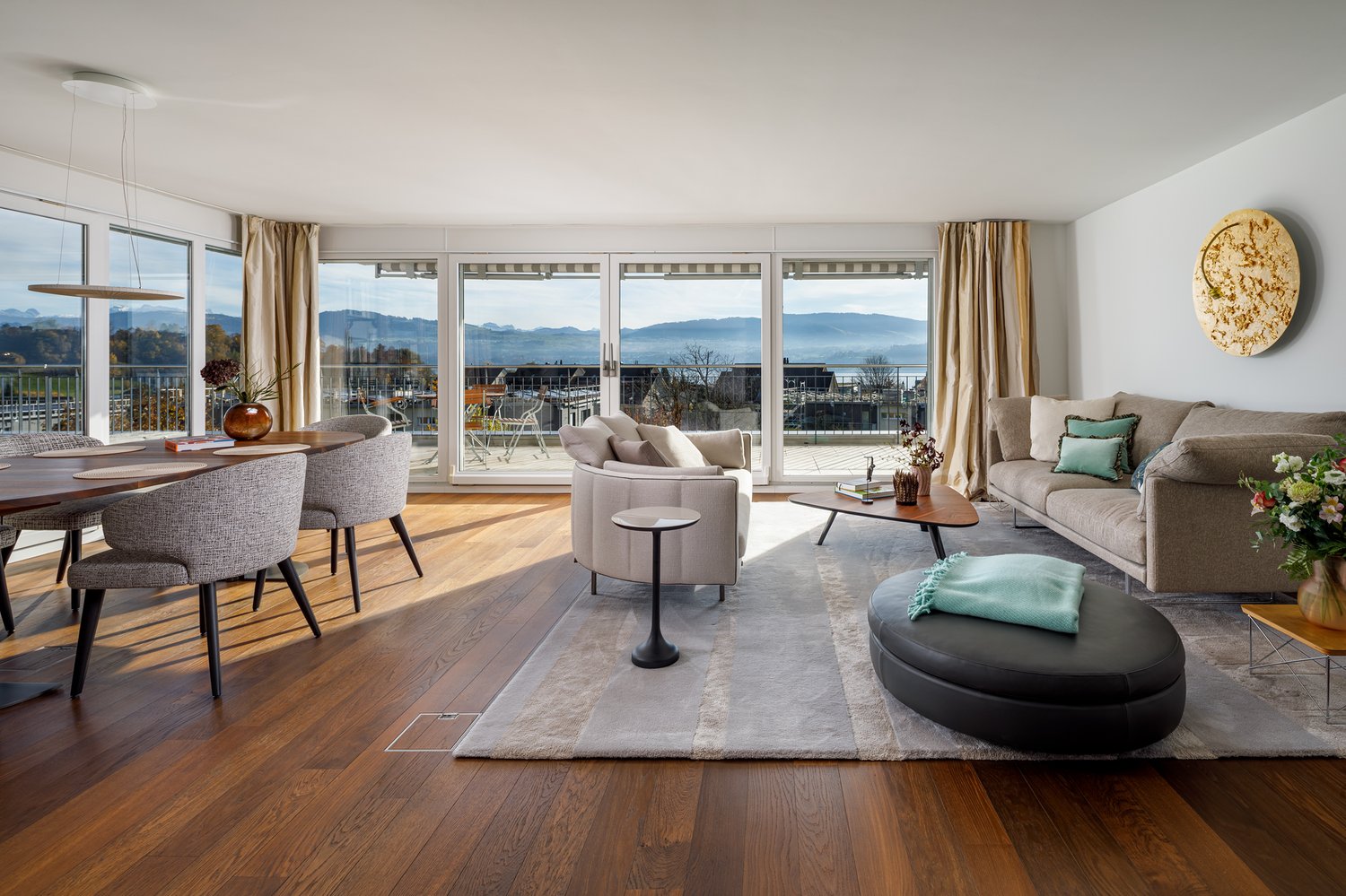 modern interior, dining table with chairs, sofa, coffee table, rug, sliding glass doors to balcony, panoramic view