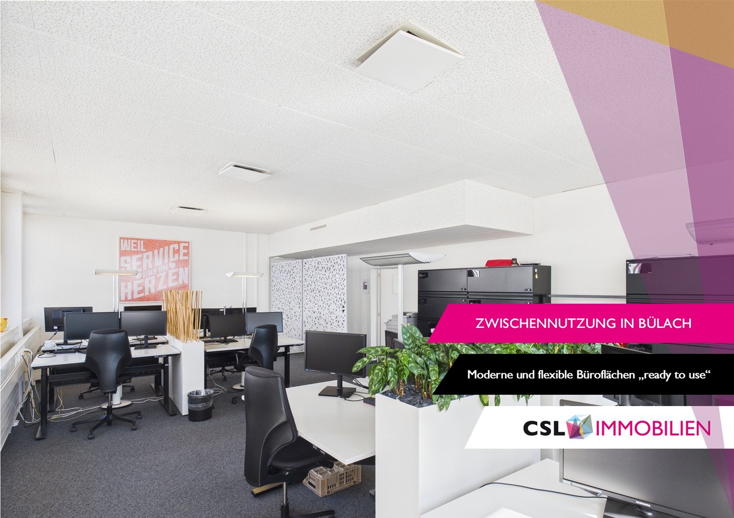 Modern and flexible office space with desks, computers, and office equipment. The space has a bright and open layout with white walls and ceilings. There is a sign indicating 'Zwischennutzung in Bulach' or 'Interim use in Bulach', suggesting this is a tem