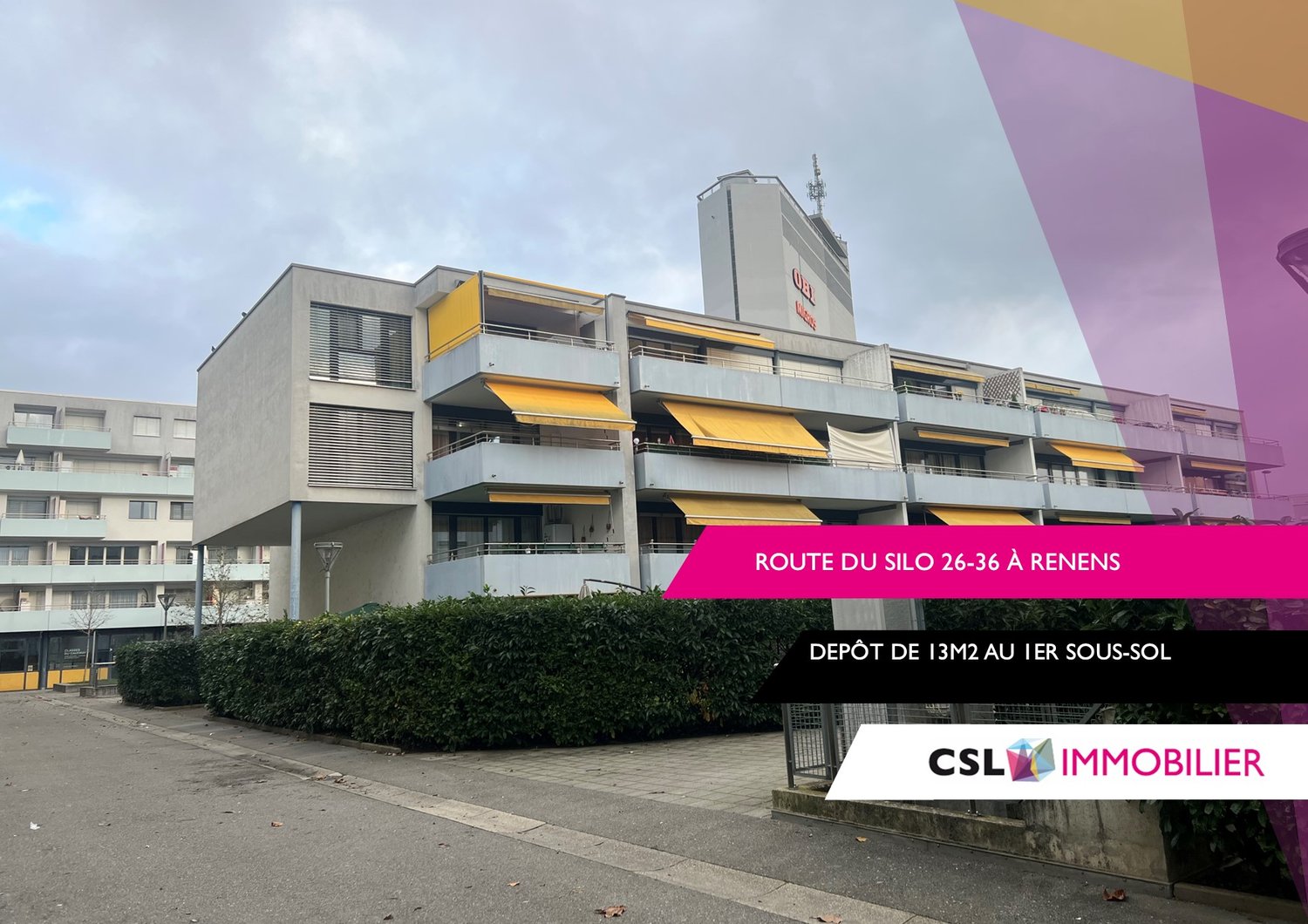 Multi-story commercial or residential building with yellow awnings and balconies, located on Route du Silo 26-36 in Renens. The building has a depot on the ground floor.