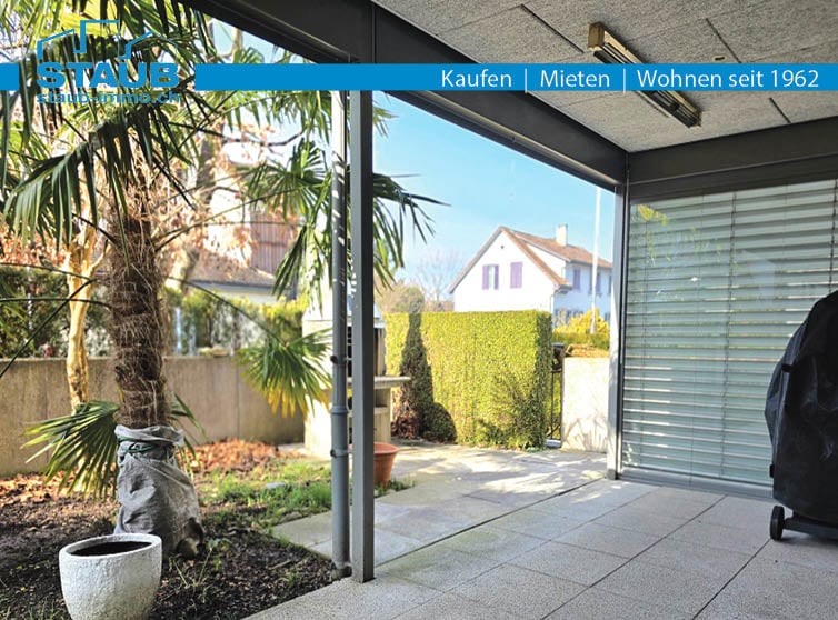 Terrace with glass wall and sliding door, outdoor furniture, plants, concrete flooring, potted plant