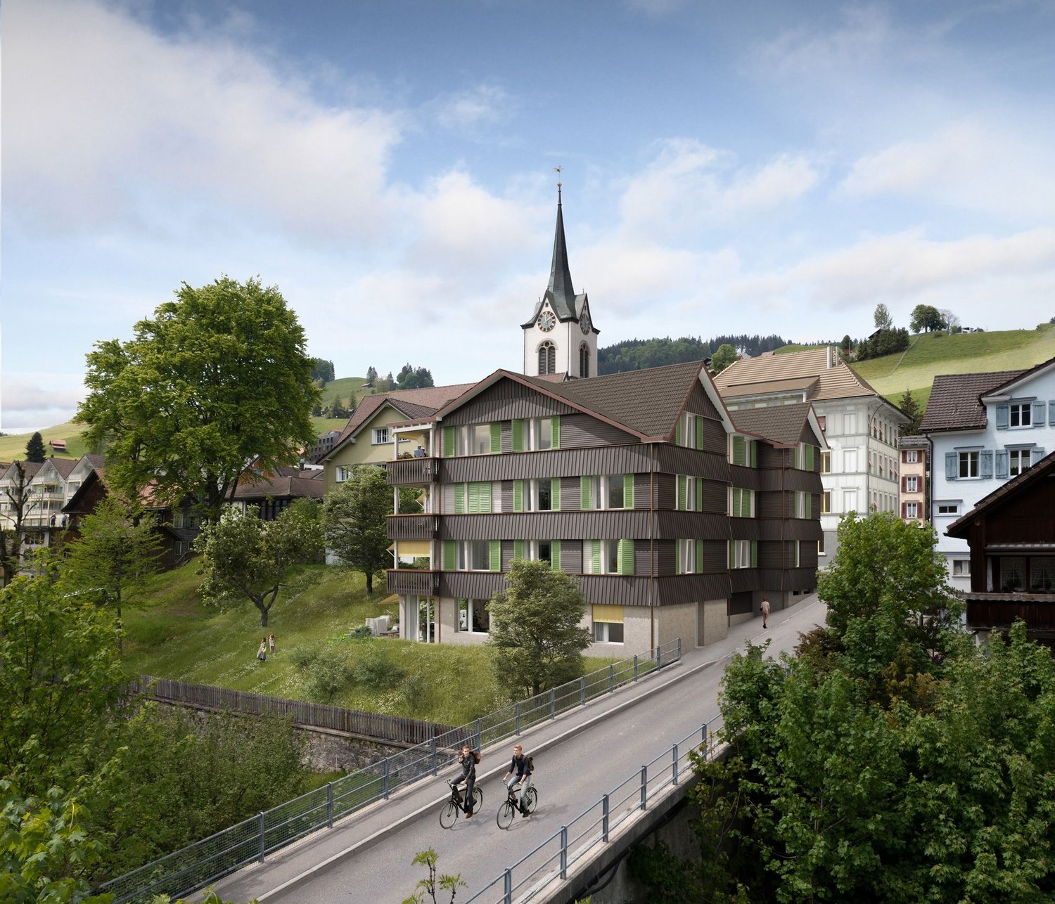 multi-story building with several balconies, church spire, steeple, clock tower, road, trees, grassy hills