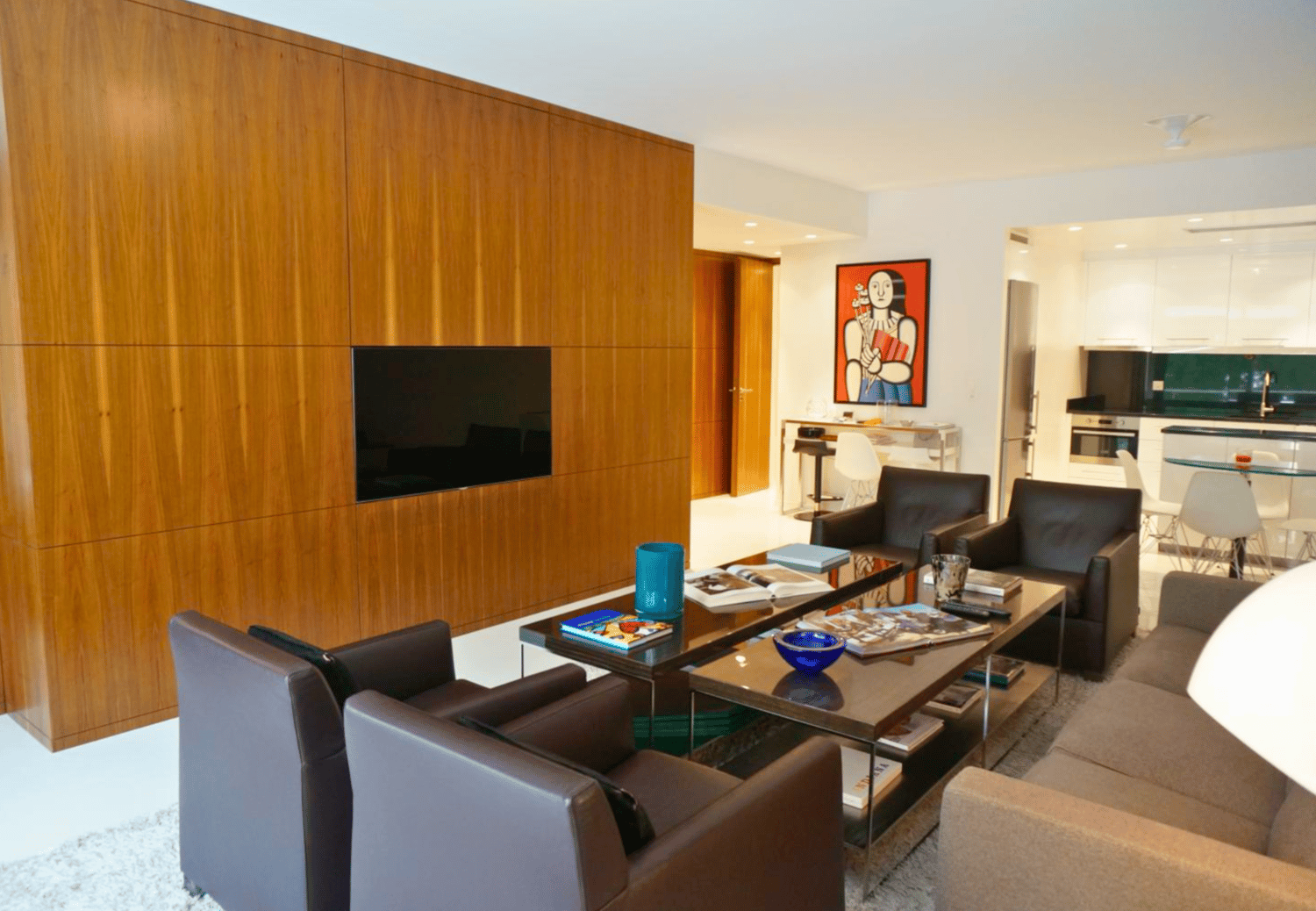 modern living room, wooden wall, flat screen TV, coffee table, armchairs, couch