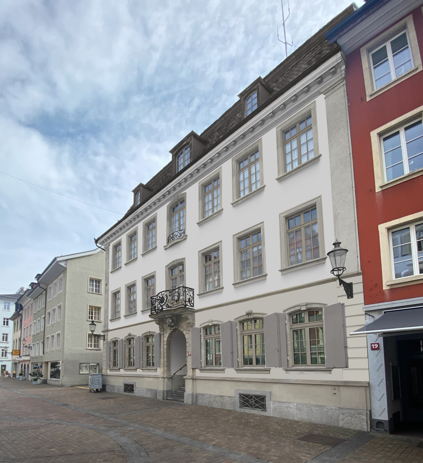 3 story building, white paint, balcony, windows, front door