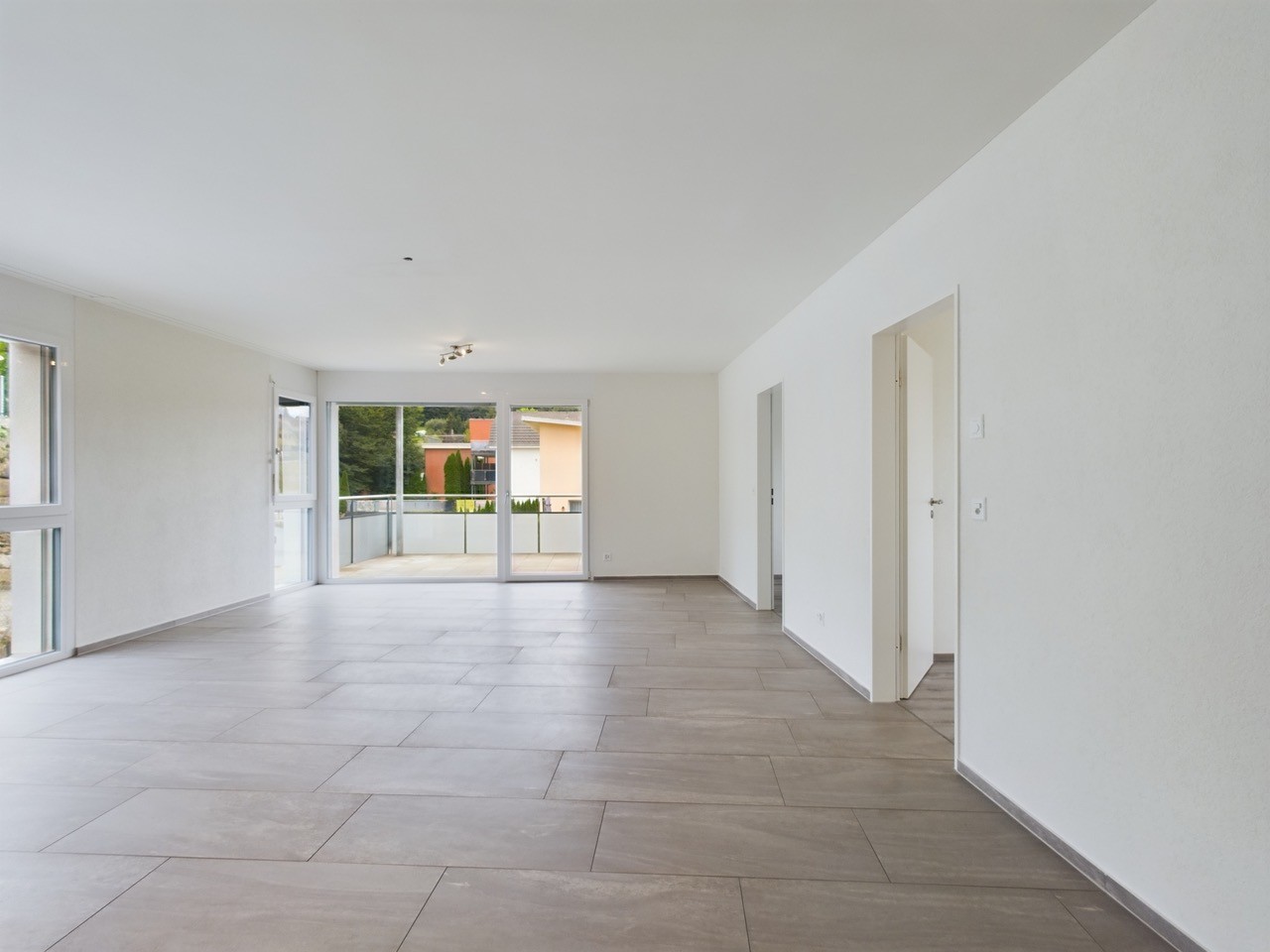 empty room, white walls, tiled floor, sliding glass doors, balcony